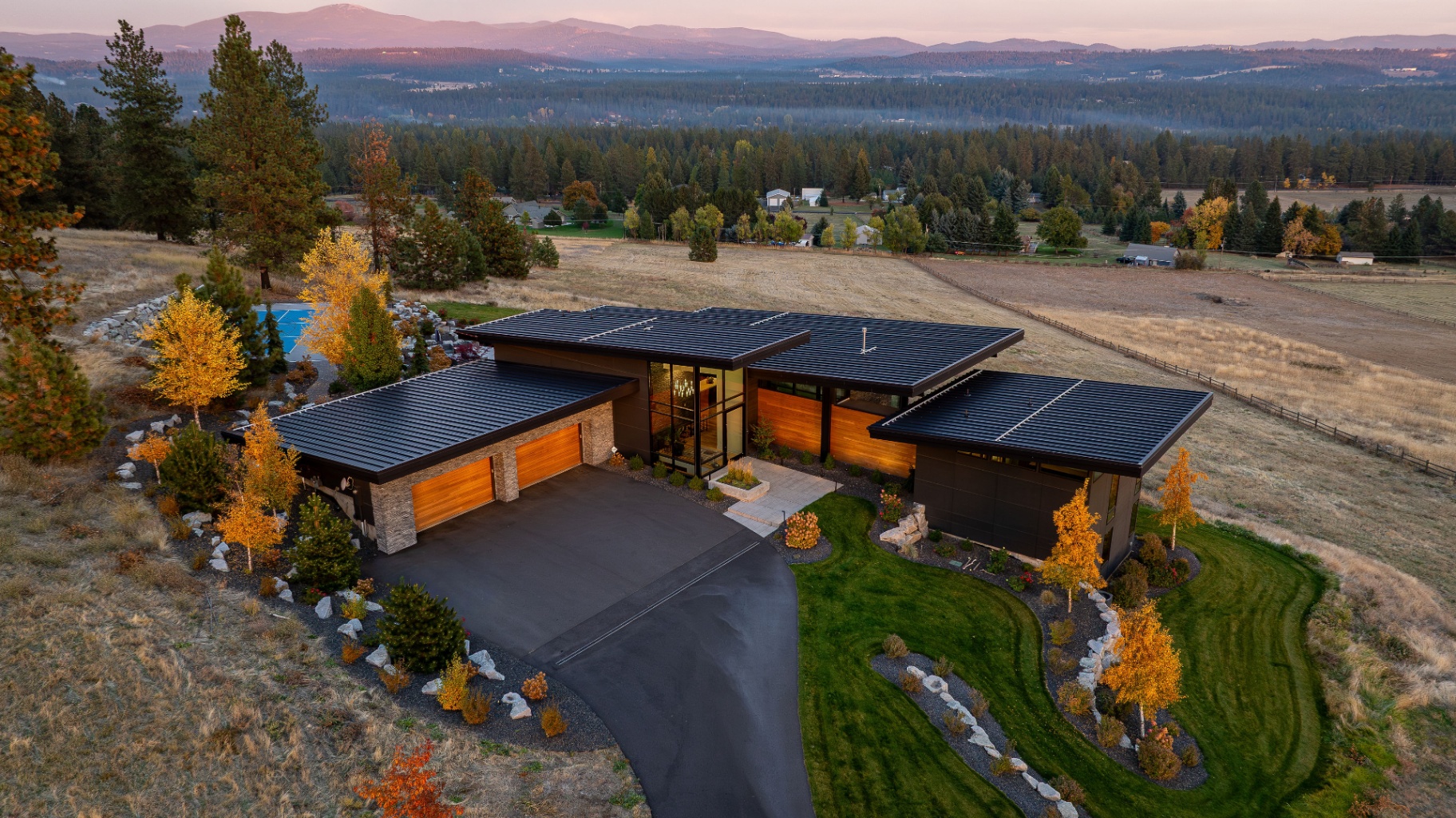 Modern Spokane luxury home aerial at sunset by Valid Media